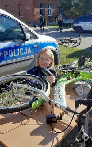 Festyn w Szkole Podstawowej w Lutowie. Policjanci znakują rowery.