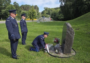 Policjanci składają symboliczną wiązankę pod pomnikiem pomordowanych policjantów.